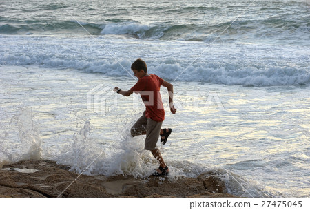 Boy runs along the seashore 27475045