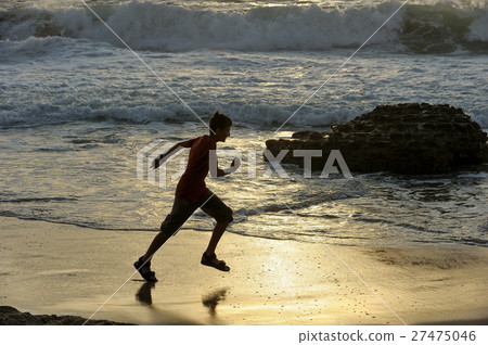Boy runs along the seashore 27475046