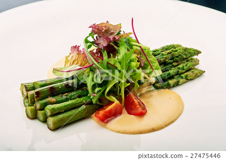 Grilled asparagus with tomatoes and arugula. Grilled asparagus with tomatoes and arugula. 27475446