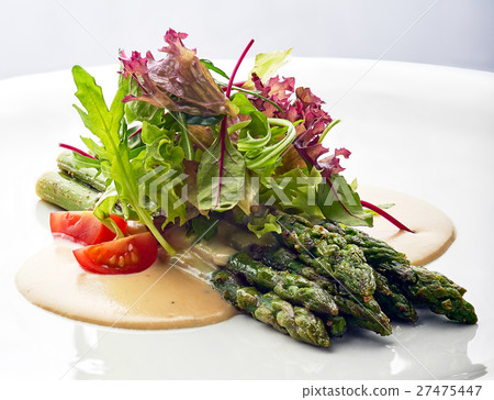 Grilled asparagus with tomatoes and arugula. Grilled asparagus with tomatoes and arugula. 27475447