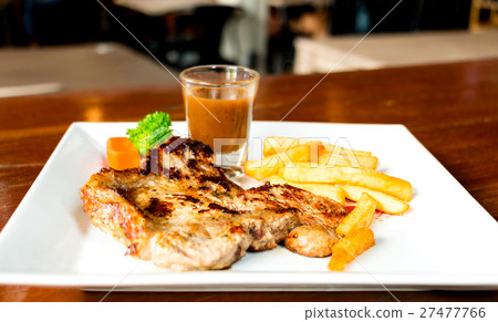 juicy porkchop on white plate 27477766