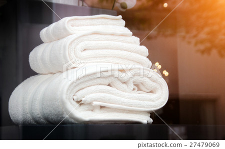 towel behind miror of toilet room 27479069