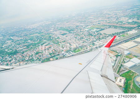 Wing of an airplane flying above the clouds . 27480906