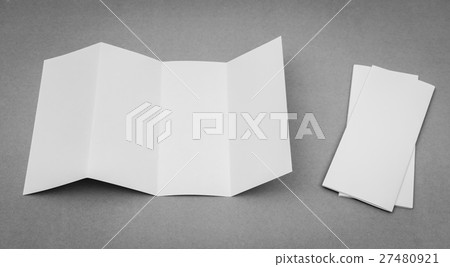 Four - fold white template paper on gray background . 27480921