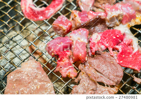 Japanese style Raw fresh beef on hot barbecue grill . 27480981