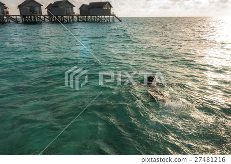 Beautiful tropical Maldives resort hotel with beach and blue water. 27481216