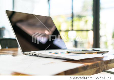Financial charts on the table with laptop . 27481265