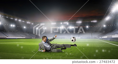 Businessman playing soccer 27483472