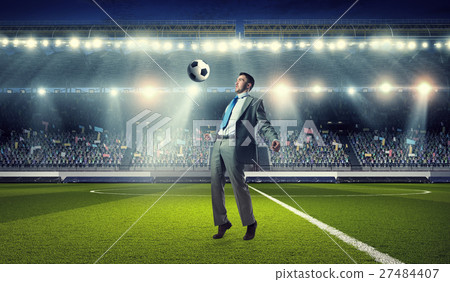 Businessman playing soccer Businessman playing soccer 27484407