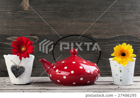 Red teapot and yellow red flower Red teapot and yellow red flower 27486295