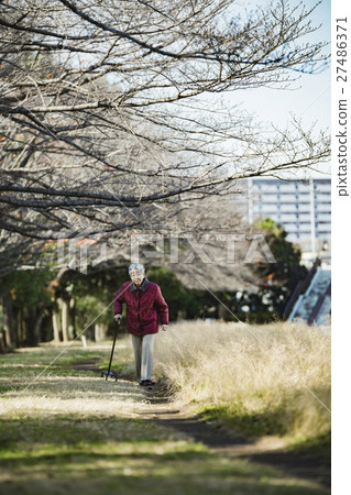 Senior woman using walking stick Senior woman using walking stick 27486371