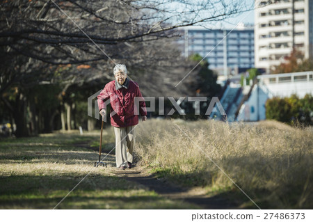 Senior woman using walking stick Senior woman using walking stick 27486373