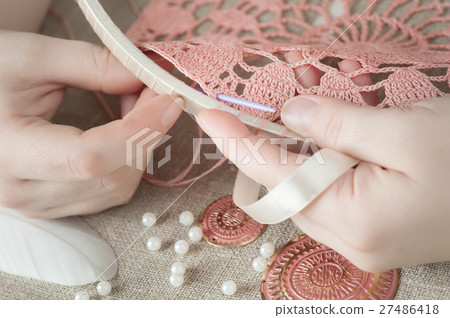 Female hands with pink knitting Female hands with pink knitting 27486418