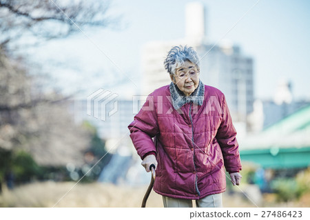Senior women using walking sticks 27486423