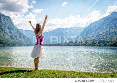 Woman meditating at the lake 27488092