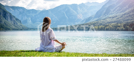Woman meditating at the lake 27488099
