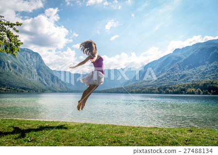 Girl jumping on the lake Girl jumping on the lake 27488134