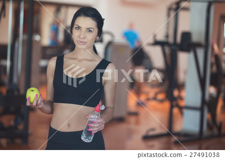 Image of beautiful young sports lady, holding an Image of beautiful young sports lady, holding an 27491038