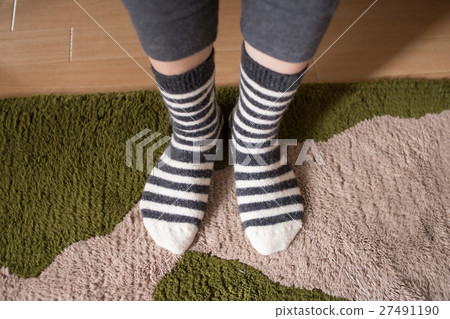 A woman's feet room wearing socks 27491190