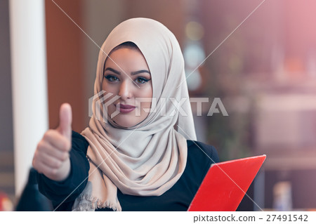 Arabian business woman holding a folder in modern Arabian business woman holding a folder in modern 27491542