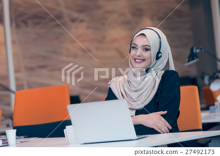 Beautiful phone operator arab woman working in 27492173