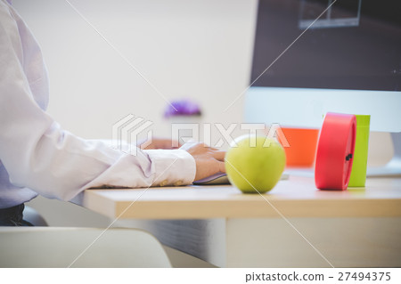 Hands of an office woman typing 27494375