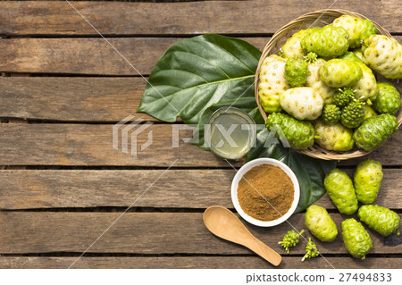 Noni fruit and noni in the basket with noni juice 27494833