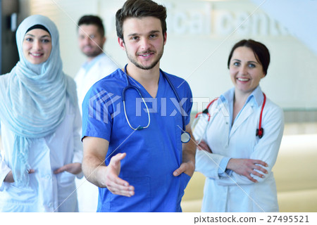 friendly male doctor with open hand ready for friendly male doctor with open hand ready for 27495521
