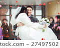 The groom carrying bride in his arms, the crowd 27497502