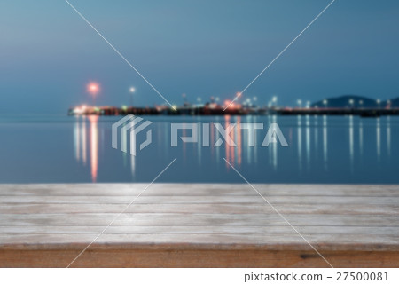Wooden top with blurred sea sunset background Wooden top with blurred sea sunset background 27500081