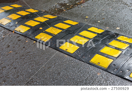 Traffic safety speed bump on an asphalt road Traffic safety speed bump on an asphalt road 27500929