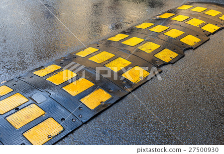 Traffic safety speed bump on an asphalt road Traffic safety speed bump on an asphalt road 27500930