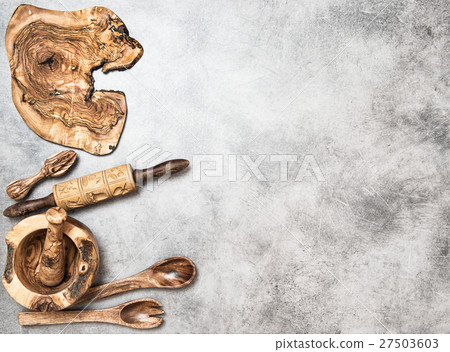 Wooden kitchen utensils on stone kitchen table Wooden kitchen utensils on stone kitchen table 27503603