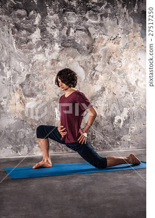 Man doing yoga exercises. Practicing yoga Man doing yoga exercises. Practicing yoga 27517250