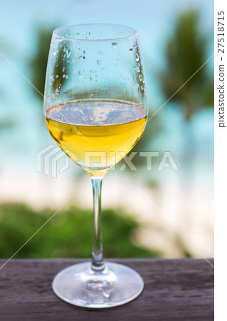 Glass of white wine on balcony rail Glass of white wine on balcony rail 27518715