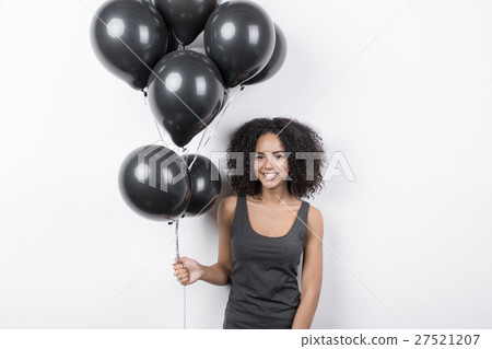 Brunette woman smiling and holding a ballons 27521207