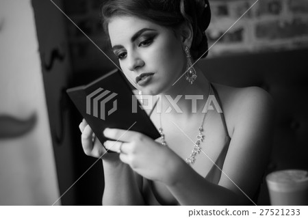 Retro image. The girl looks in the mirror 27521233