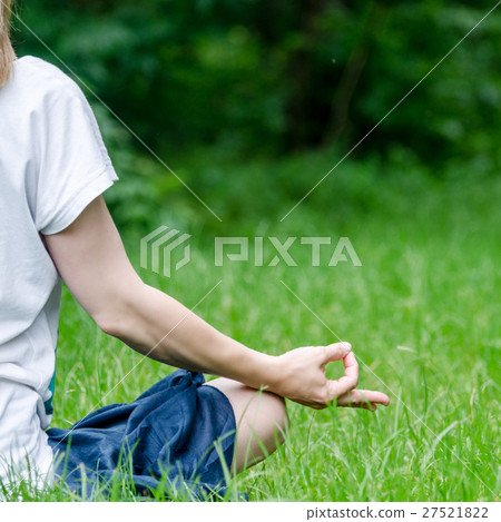 Woman doing yoga in the park Woman doing yoga in the park 27521822