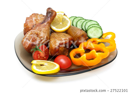 Grilled chicken legs with vegetables on a plate. 27522101