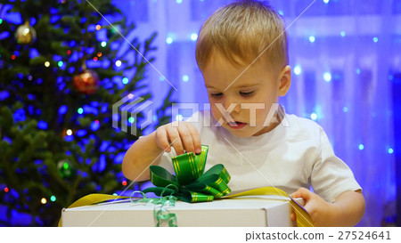Christmas gift surprise - A child opens present 27524641