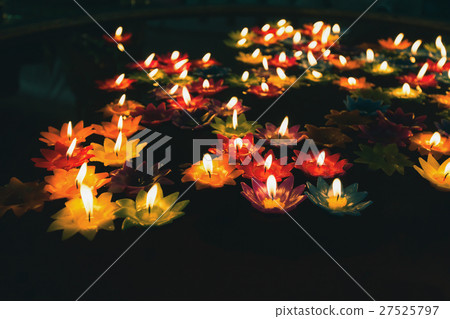 Colorful candle with fire on oil pool 27525797