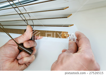 Installing wooden blinds. 27526515