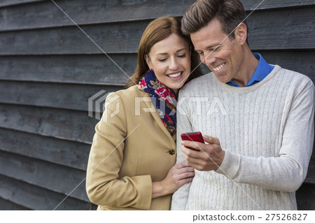 Middle Aged Man Woman Couple and Cell Mobile Phone Middle Aged Man Woman Couple and Cell Mobile Phone 27526827