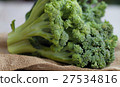 Bunch of fresh green broccoli on wooden background 27534816