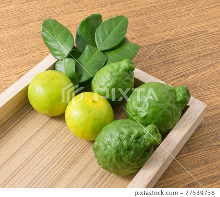 Green Kaffir Lime with Lemon Lime on Wooden Tray 27539738