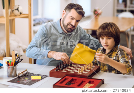 Positive delighted friends playing chess 27540924