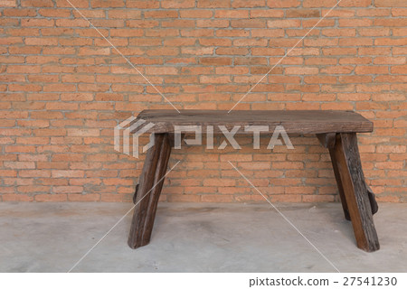 Wooden bench over grunge bricks wall background 27541230
