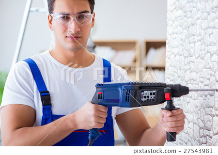 Repairman working with drilling drill perforator Repairman working with drilling drill perforator 27543981