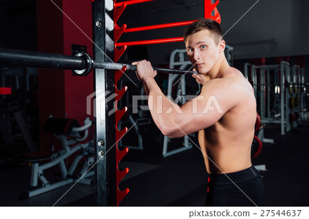 portrait of a handsome athlete at gym. man does 27544637