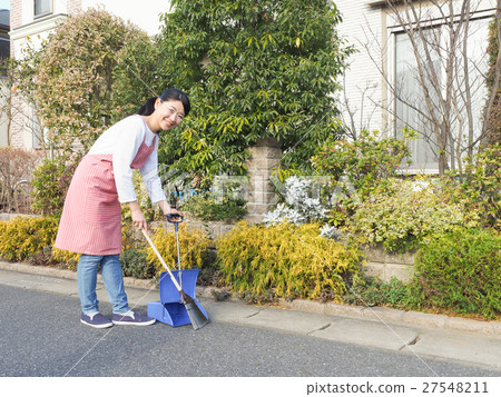 A woman cleaning the front of the house 27548211